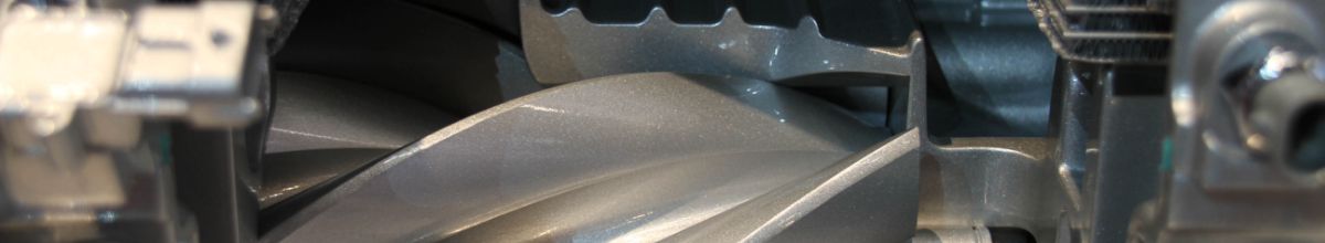 Close-up of a machined metal impeller wheel among engine components
