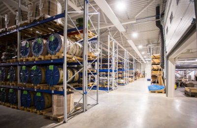 Racking bays holding coiled goods and packaged components in a small warehouse